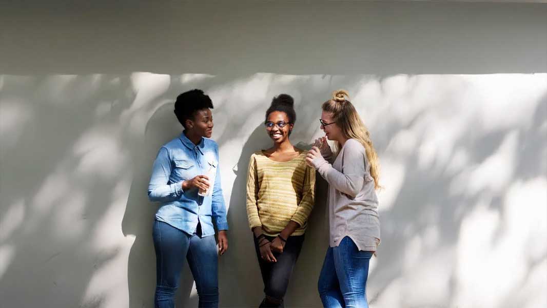 Three students having a conversation